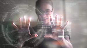 Image of a woman behind the palms of her hands, her expression is of wonder and delight as she plays with data sets magically appearing before her. 