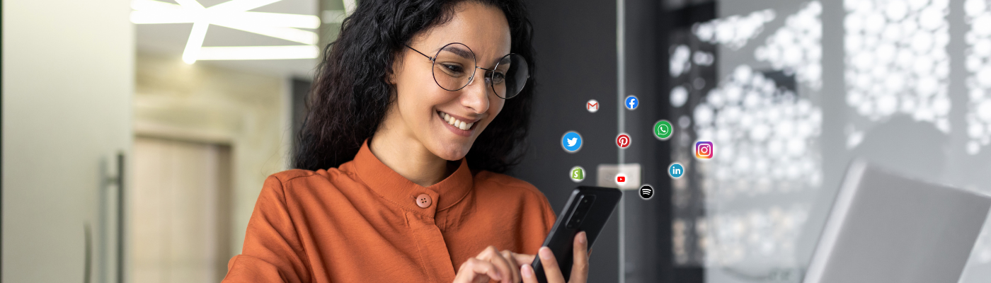 Woman smiling and looking down at a phone.