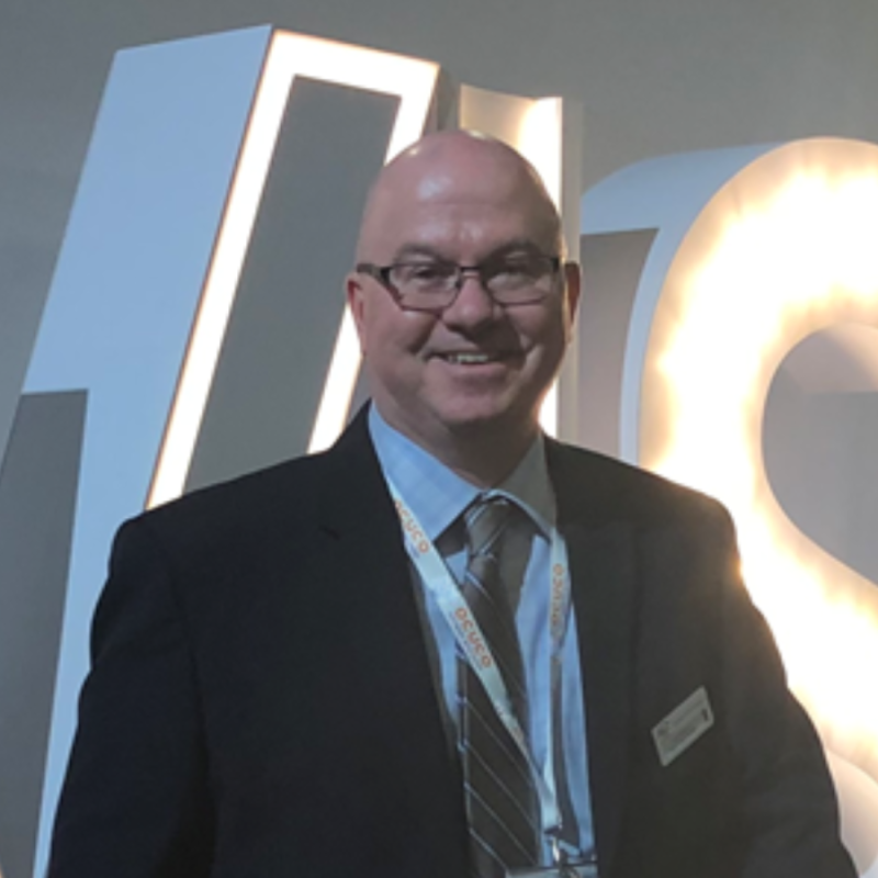 A photo of Russell Gagain. He is wearing glasses and a navy suit.